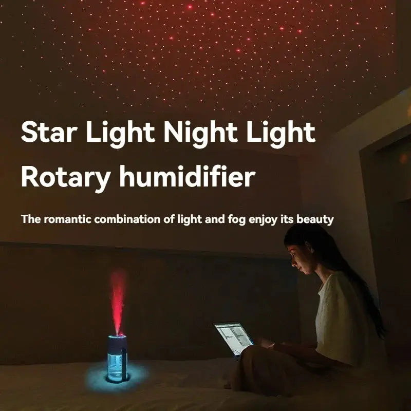 starry night projector light humidifier with pink light while girl using laptop